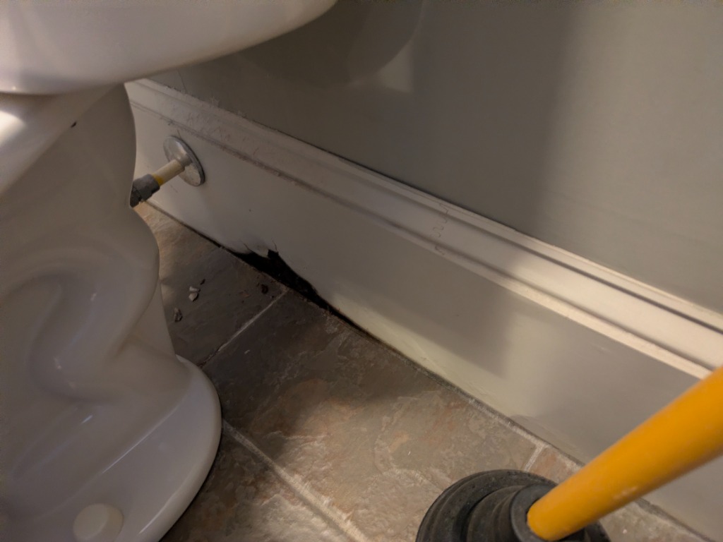 Visible water damage near toilet base
